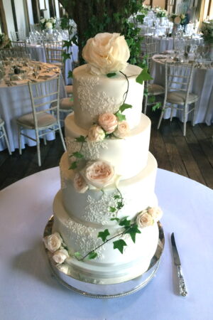 Featuring fresh roses and piped alencon lace at Loseley Park