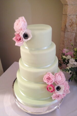 Four tier mint cake with sugar peonies, roses, anemones & ranunculus - at Farnham Castle